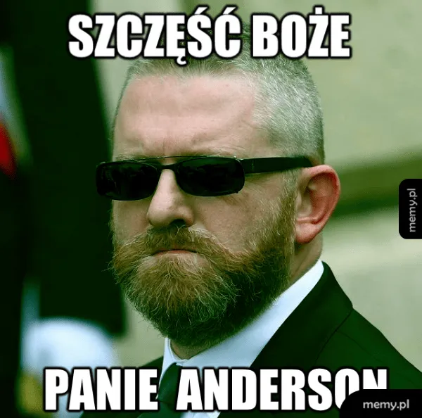 Grzegorz Braun w czarnych okulary przeciwsłonecznych przypominający Agent Smith z Matrixa