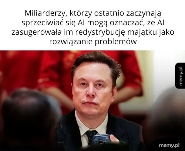 Elon Musk siedzący przy stole z poważną miną